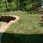 Retaining wall provided this home with additional lawn area, while preventing erosion.